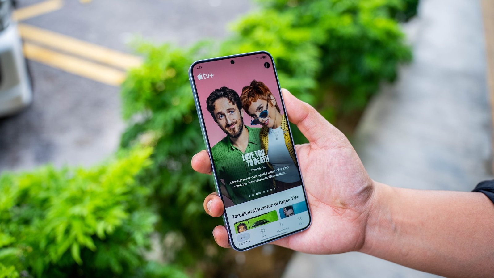 A person holding a cell phone in their hand