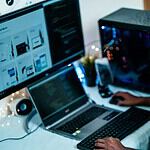 man in blue dress shirt using computer