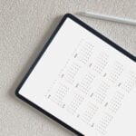 a black and white calendar sitting on top of a table