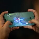 Hands holding a smartphone playing a video game.