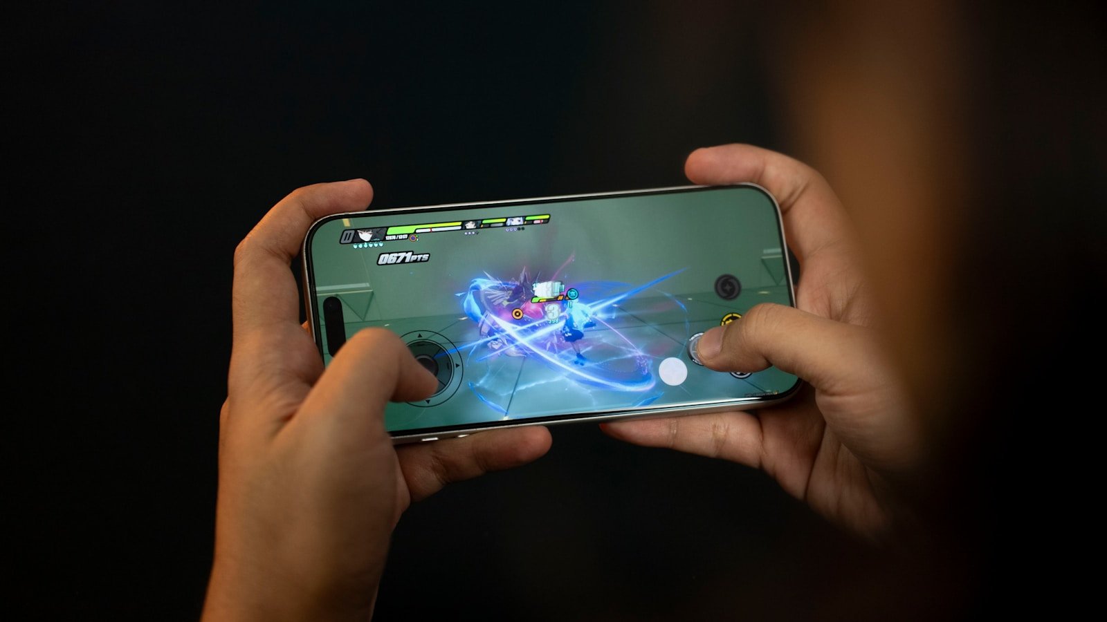 Hands holding a smartphone playing a video game.
