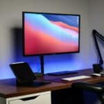a computer monitor sitting on top of a wooden desk