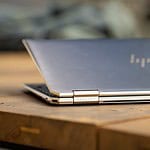 silver macbook on brown wooden table