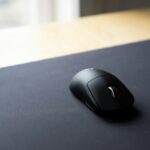 black cordless computer mouse on black surface