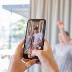 a person taking a picture of a man and woman