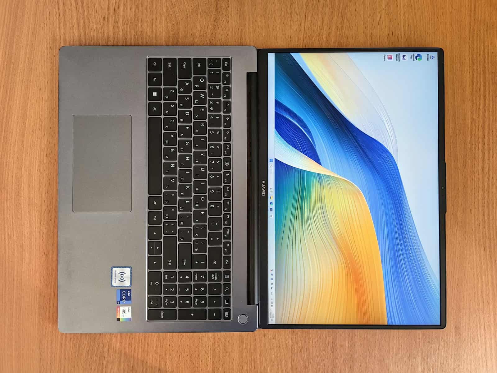 a laptop computer sitting on top of a wooden table