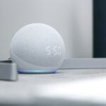 gray round portable speaker on white table