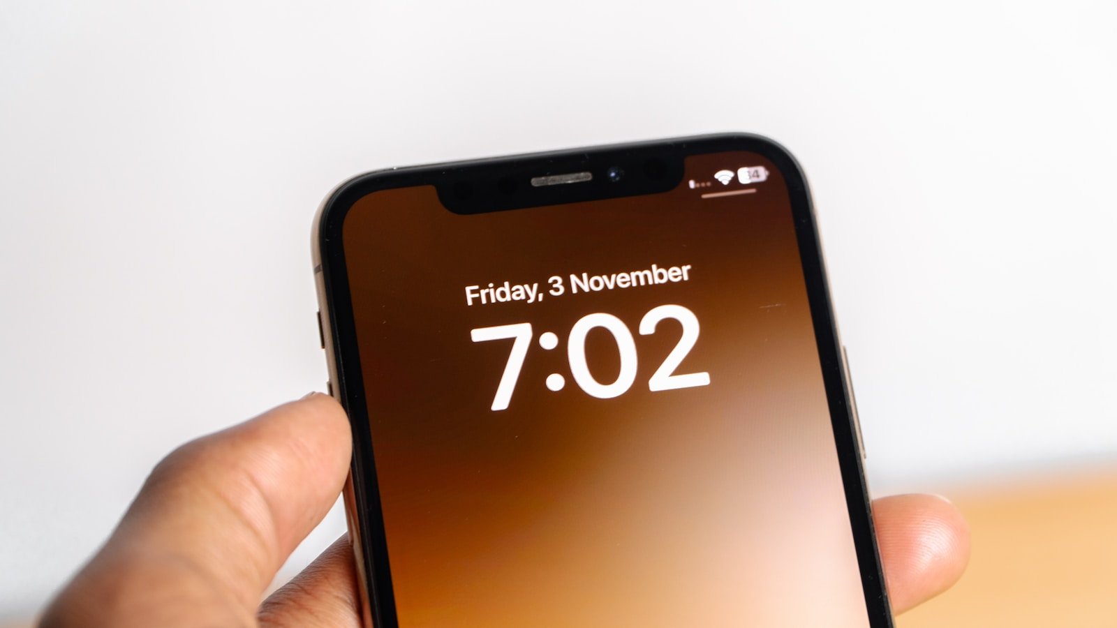 a person holding a cell phone with the time on it