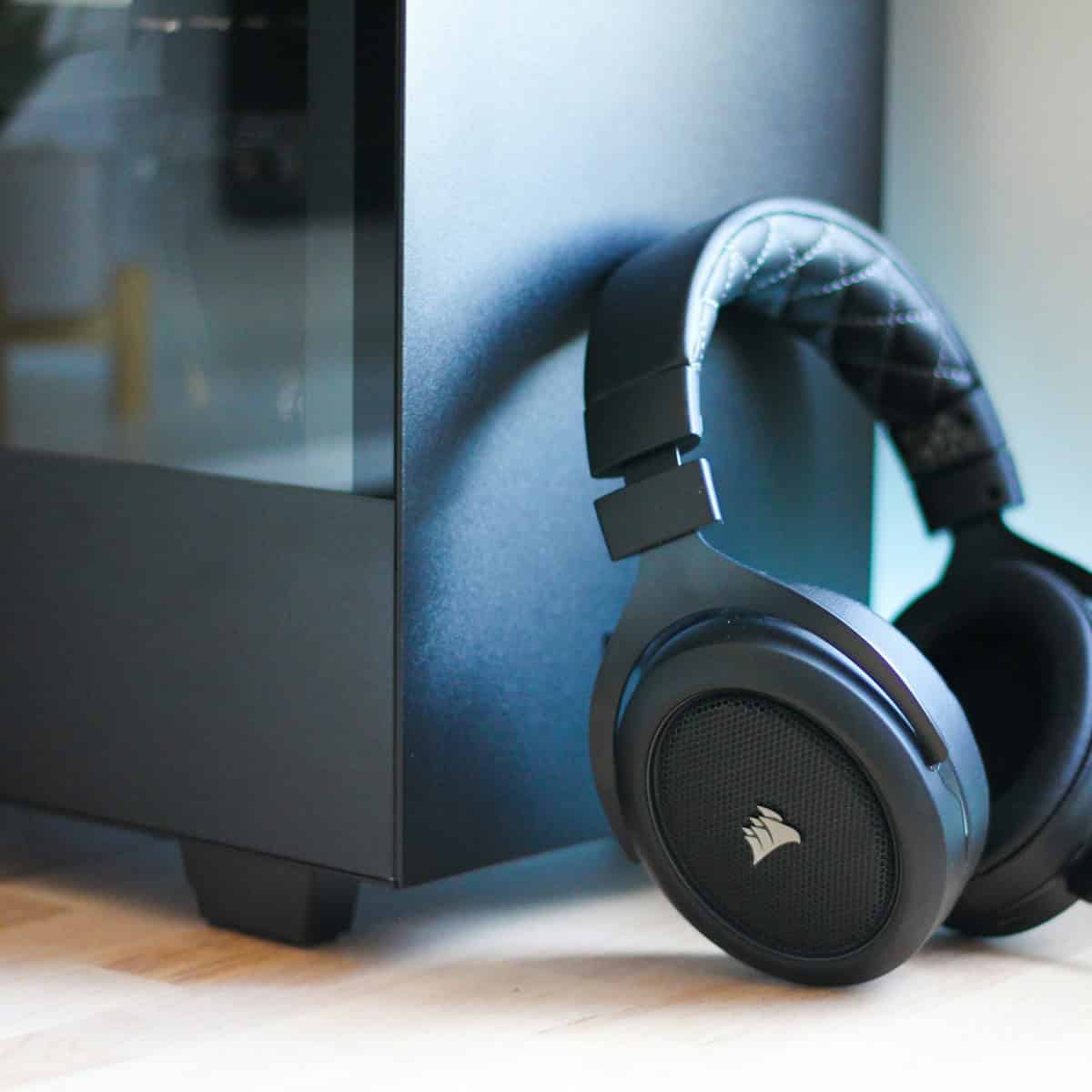 Corsair black headphones beside cabinet