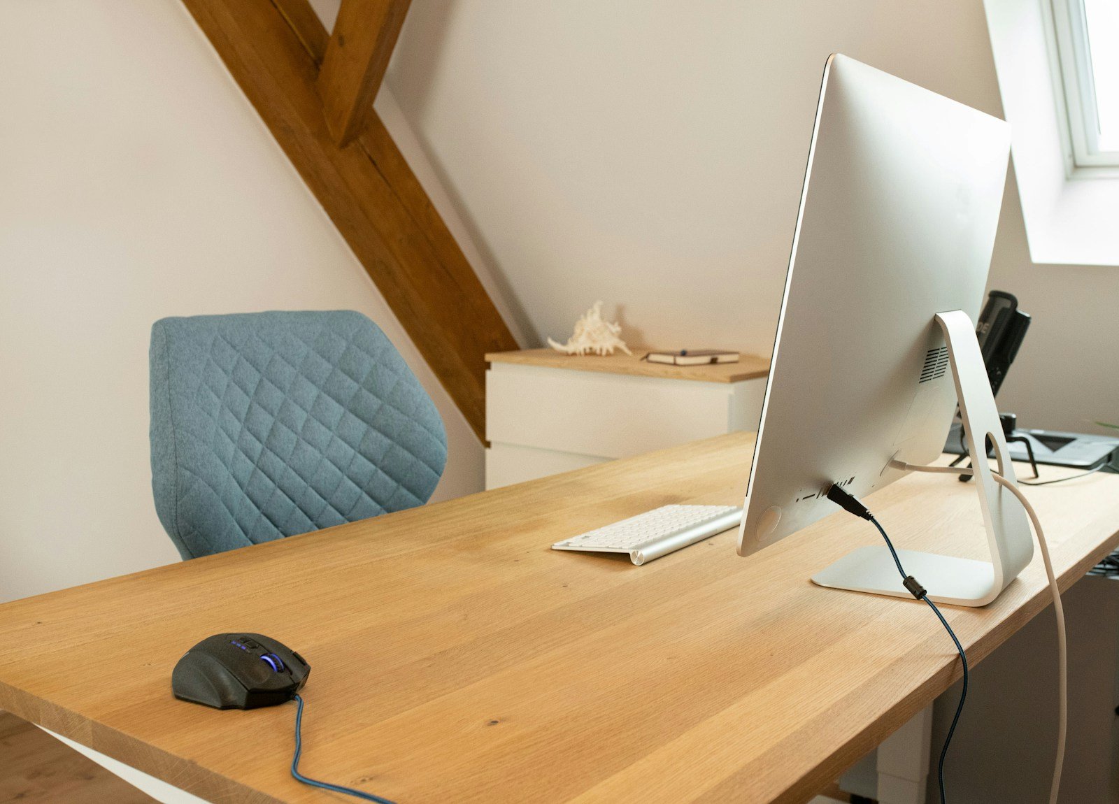a computer monitor sitting on top of a wooden desk