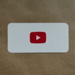 a white card with a red youtube logo on it