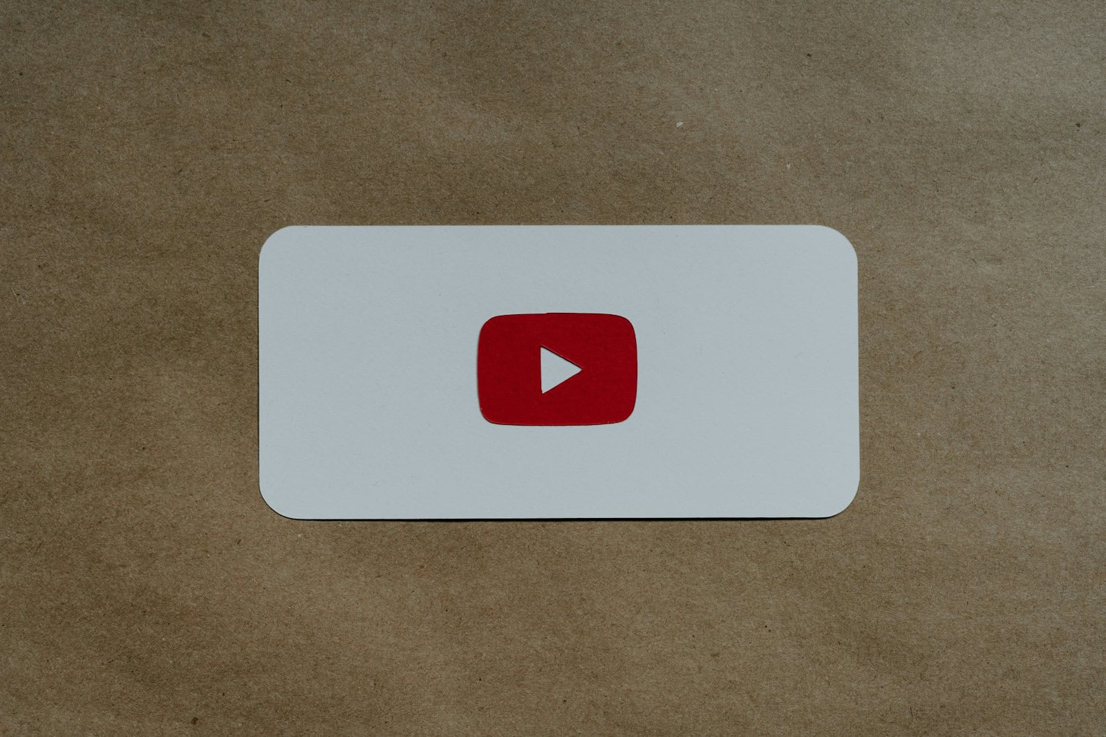 a white card with a red youtube logo on it