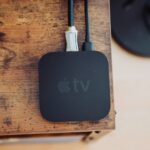 black apple tv on brown wooden table