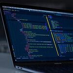 turned-on MacBook Pro wit programming codes display