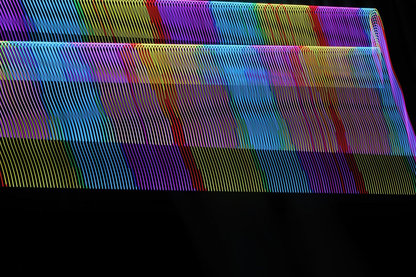 A close up of a multicolored object on a black background