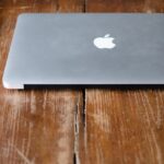 photo of MacBook Pro beside black Android smartphone