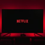 a television with the netflix logo lit up in the dark