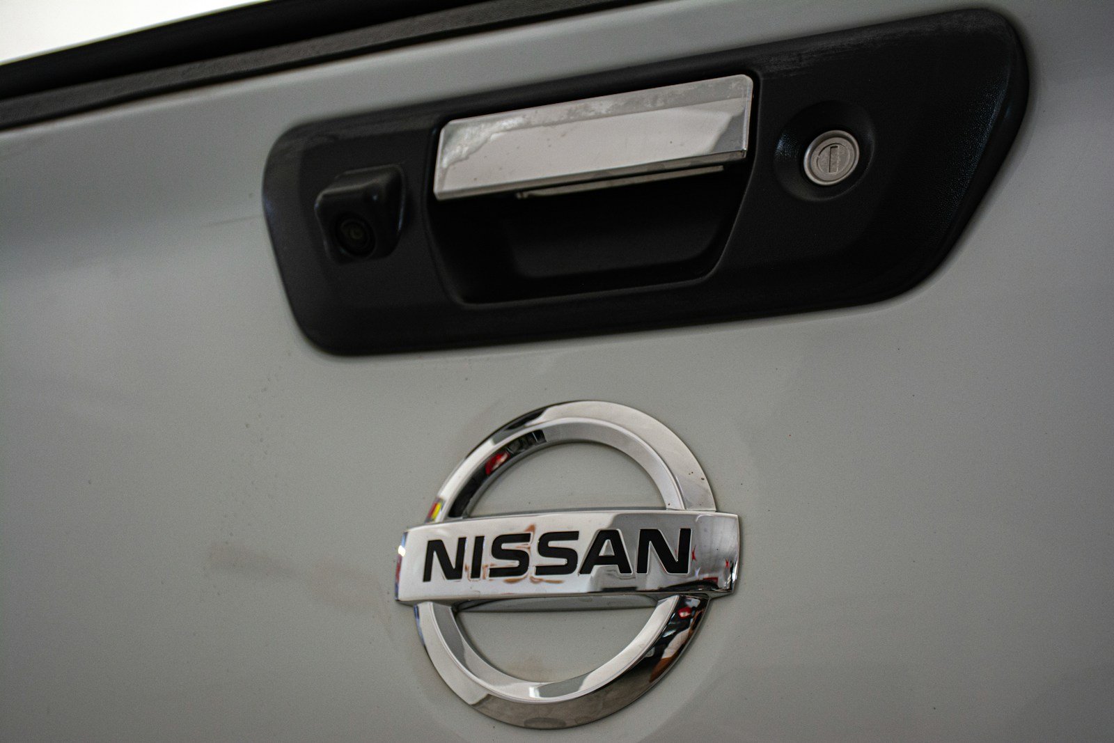 a close up of a nissan emblem on a car