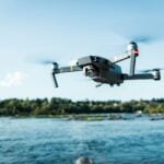 black DJI Mavi quadcopter near body of water
