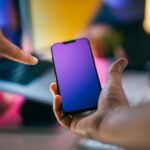 A person holding a cell phone in their hand