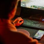 A man playing a video game on his computer