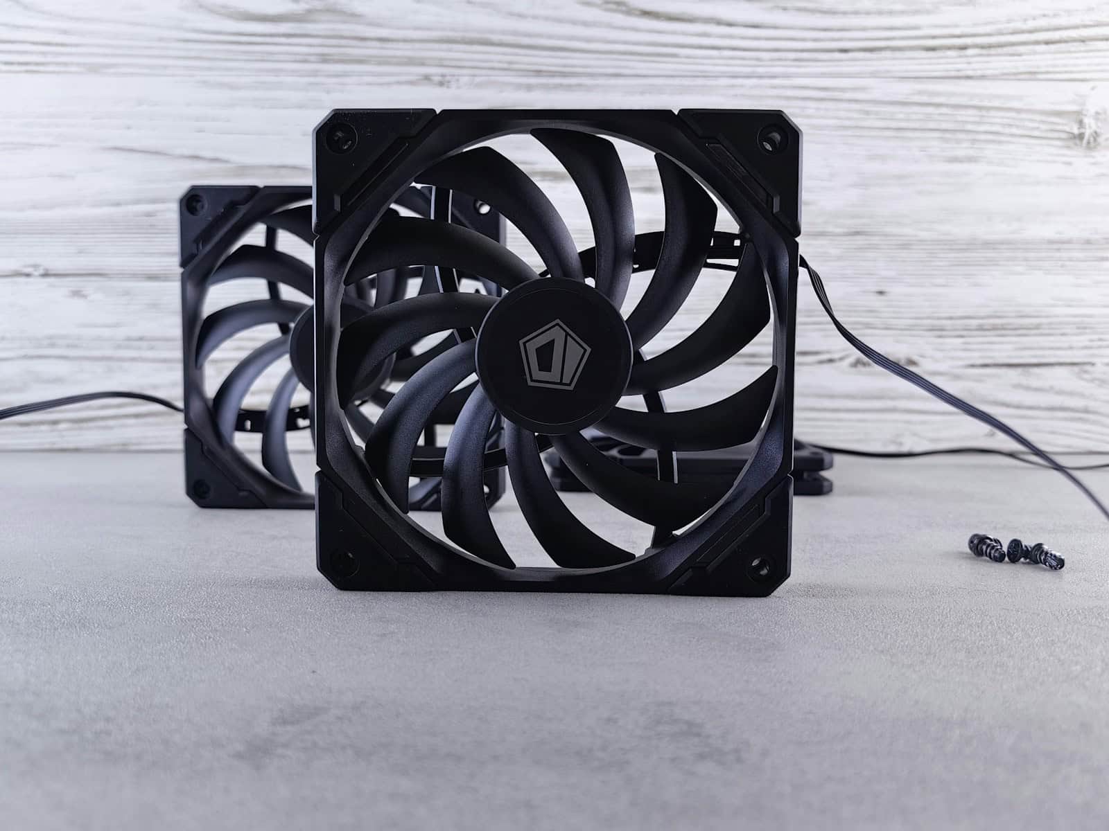 a couple of black fans sitting on top of a table