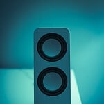 black and gray speaker on blue surface