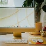 silver imac on brown wooden table