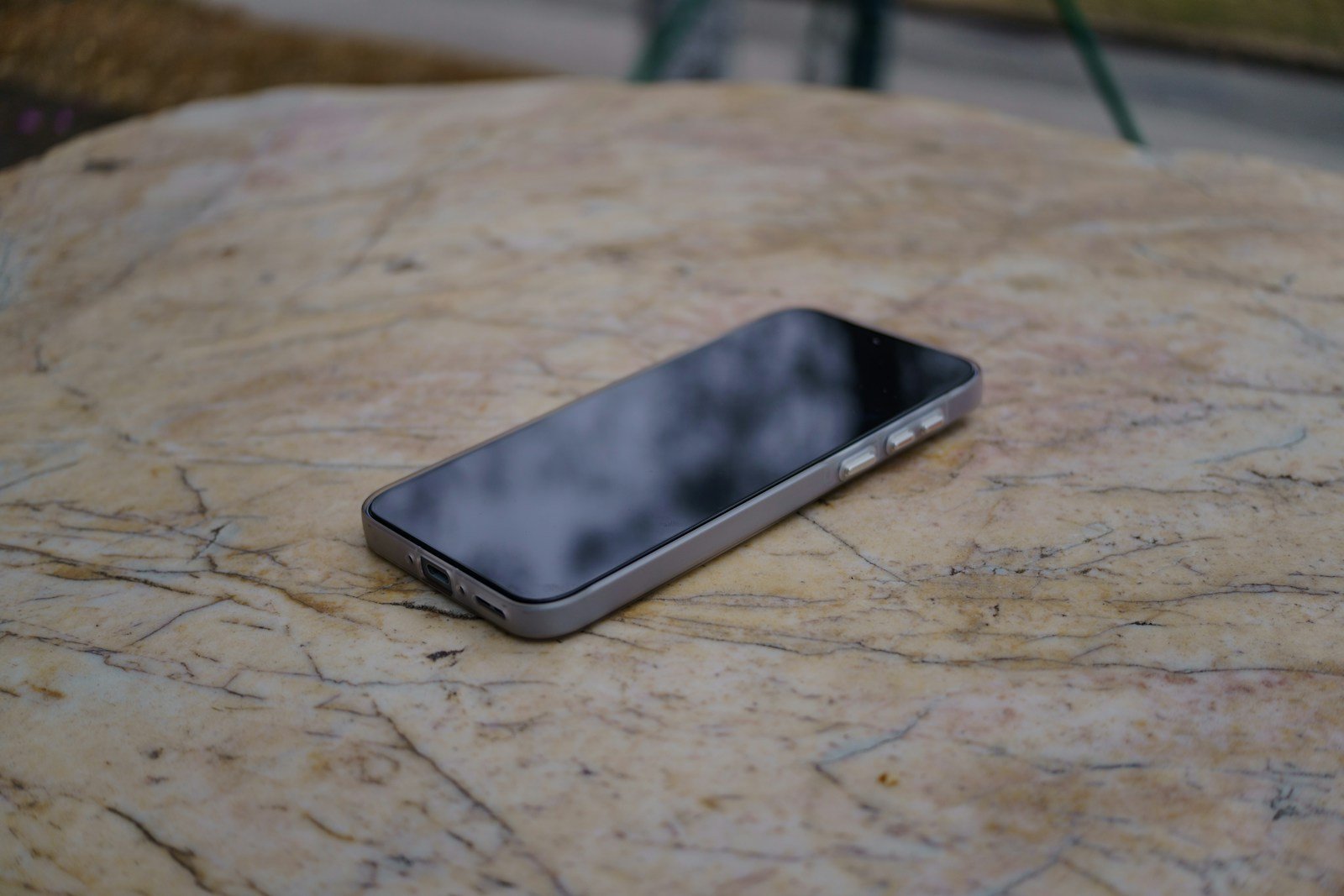 A smartphone rests on a textured surface.