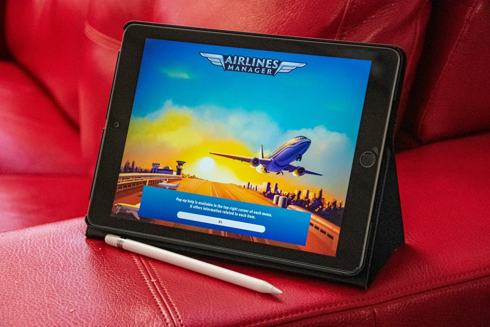 a tablet sitting on top of a red couch