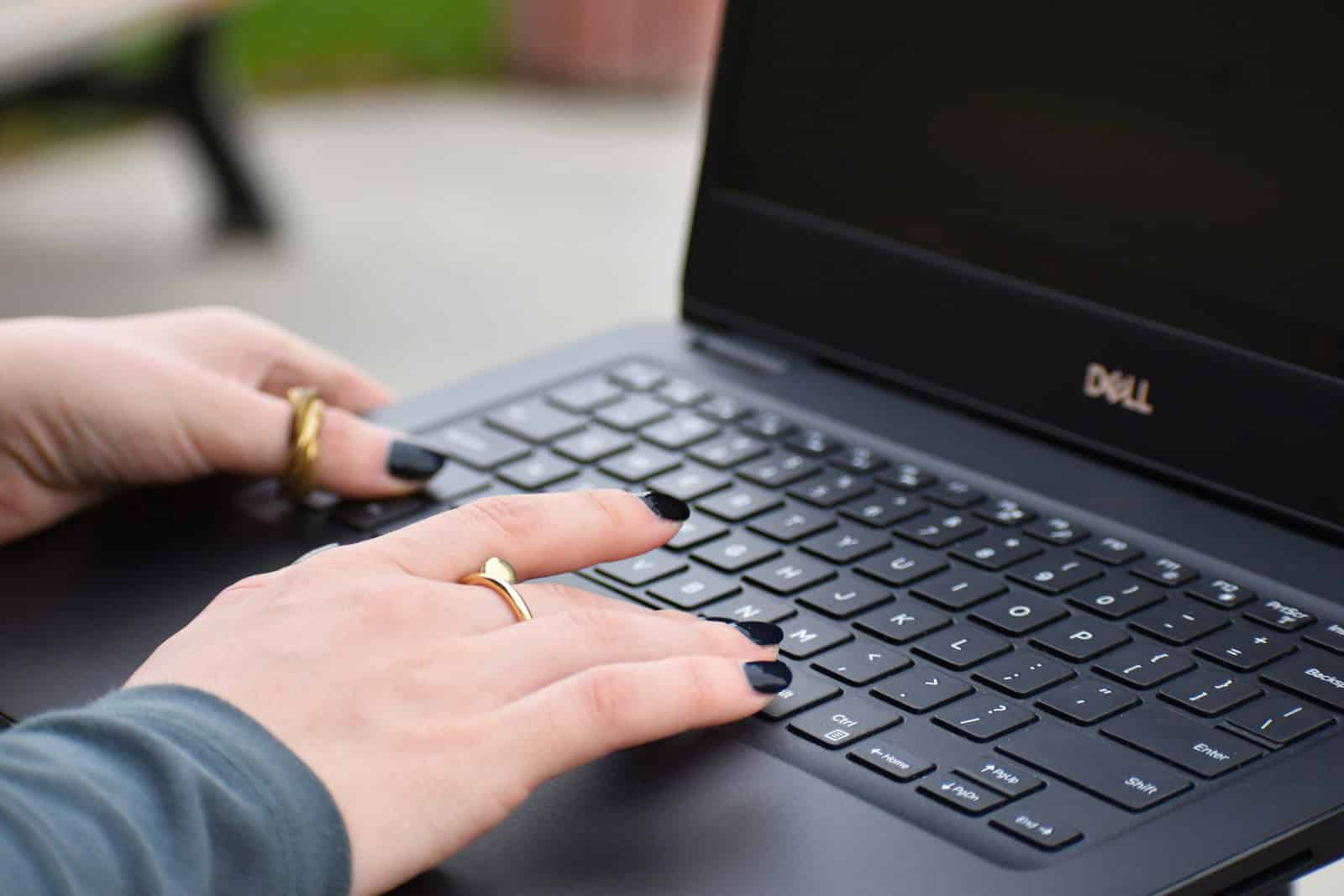 a person typing on a laptop