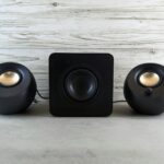 Three speakers sitting on top of a table