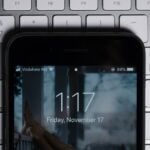 black iPhone on gray computer keyboard