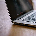 MacBook Pro on brown wooden table