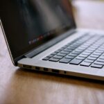 MacBook Pro on brown wooden table